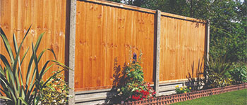 Concrete Posts used on this fencing line of golden brown fence panels