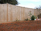 Featheredge Fencing over a bricked wall driveway