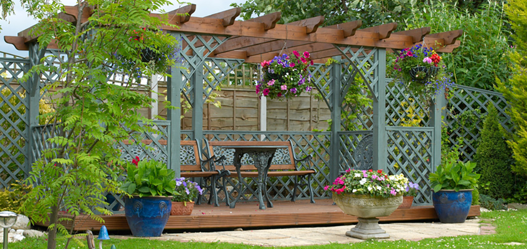 Pergola with painted trellis panels and planters on a bank holiday