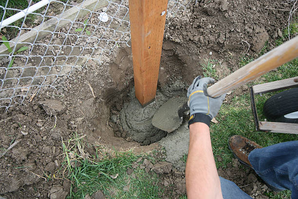 Timber Fence Post being set in to ground with Postmix