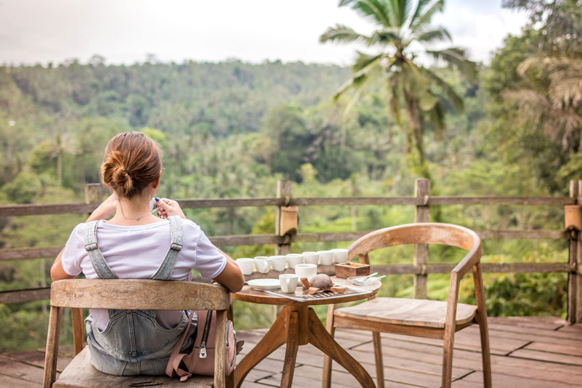 Lady Sitting on a Garden Chair situated on a Decking area