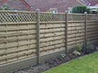 Wooden fence panels using the ECO PVC gravel board under the wooden panel for protection
