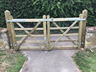 A pair of field gates closed with wire fencing attached