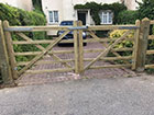 A pair of field gates closed on a driveway