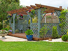 A large pergola using trellis panels for walls